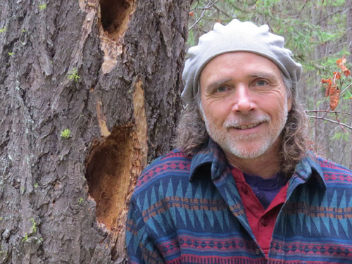 Scott Royder standing in front of a tree